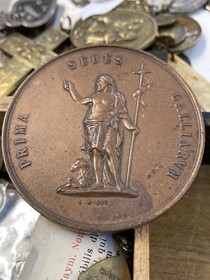 Lot 450 - Religious Artefacts. A Victorian yellow metal cross and religious medals