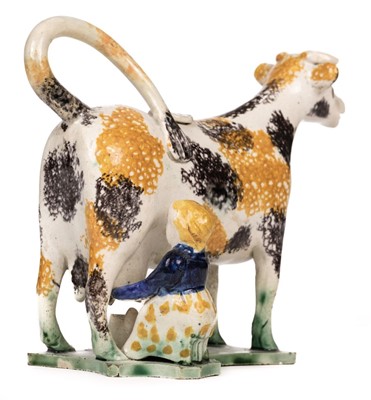 Lot 254 - Cow Creamer. An 19th century Yorkshire creamware cow creamer and cover