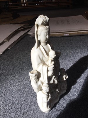 Lot 8 - Blanc de Chine Guanyin porcelain figural group, Qing, circa 1670