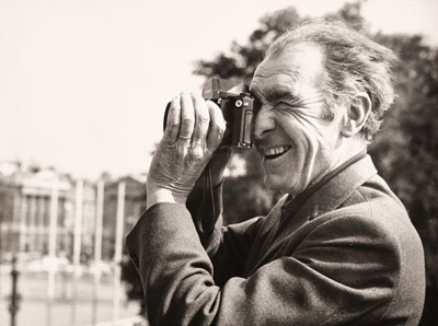 Lot 130 - Doisneau (Robert, 1912-1994). Candid portrait of the photographer with his camera