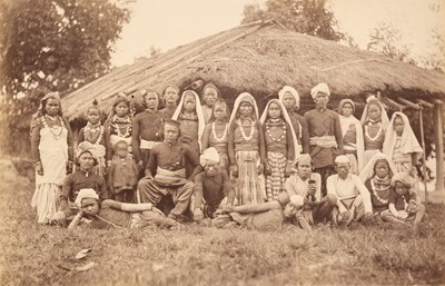 Lot 171 - India. A large group of Bhootea and Nepalese tea plantation workers posing outside a thatched dwelling