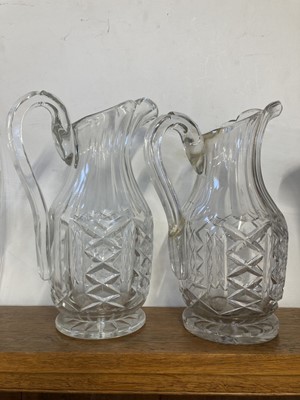 Lot 558 - Jugs. A near pair of Edwardian Waterford crystal glass jugs, circa 1910