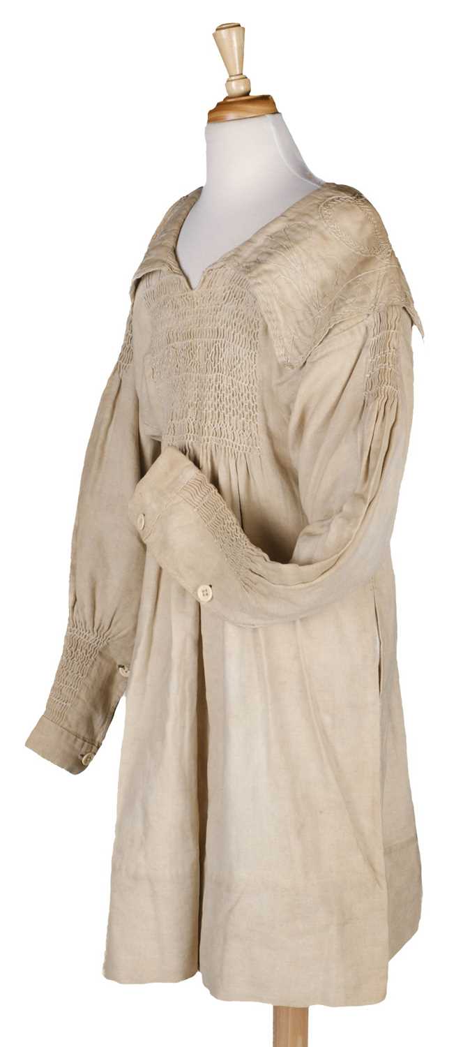 Lot 477 - Clothing. A 19th century farm worker's smock, and child's smock and bonnet, circa 1880