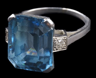 Lot 598 - Ring. An art deco style white metal ring, set with a large step cut aquamarine