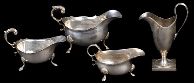 Lot 607 - Cream Jug. A modern silver helmet shape cream jug and sauce boats