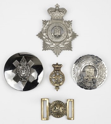 Lot 82 - Military Cap Badges. A mixed collection of badges and belt buckles