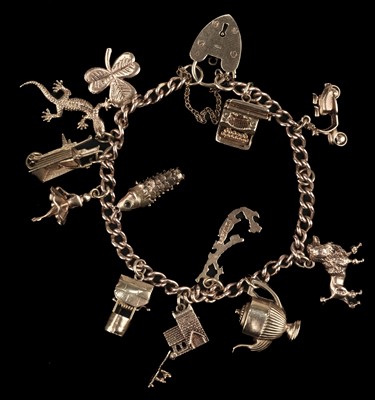 Lot 517 - Charm Bracelet. A 9ct gold charm bracelet, 37.6g