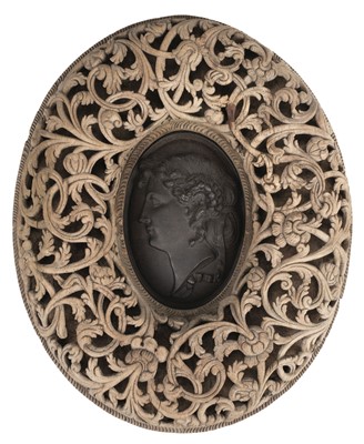 Lot 42 - Continental School. A cast iron oval plaque depicting a classical female head in profile, 19th c.