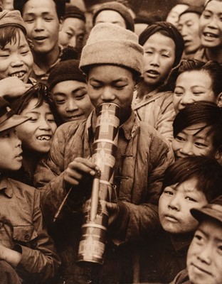 Lot 15 - China. A group of children around a boy smoking a water pipe made of beer cans, c. 1930