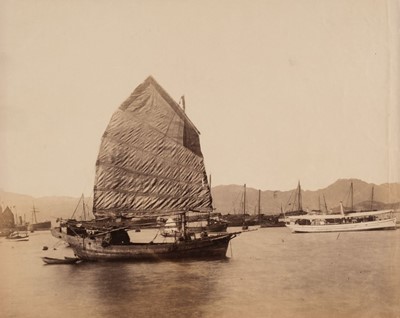 Lot 52 - Hong Kong. A Chinese sampan with raised sail in the harbour, looking north, c. 1890s, albumen print