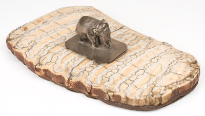 Lot 578 - Desk weight. Two white metal elephants, 19th century, mounted on a slice of fossilised mammoth tooth