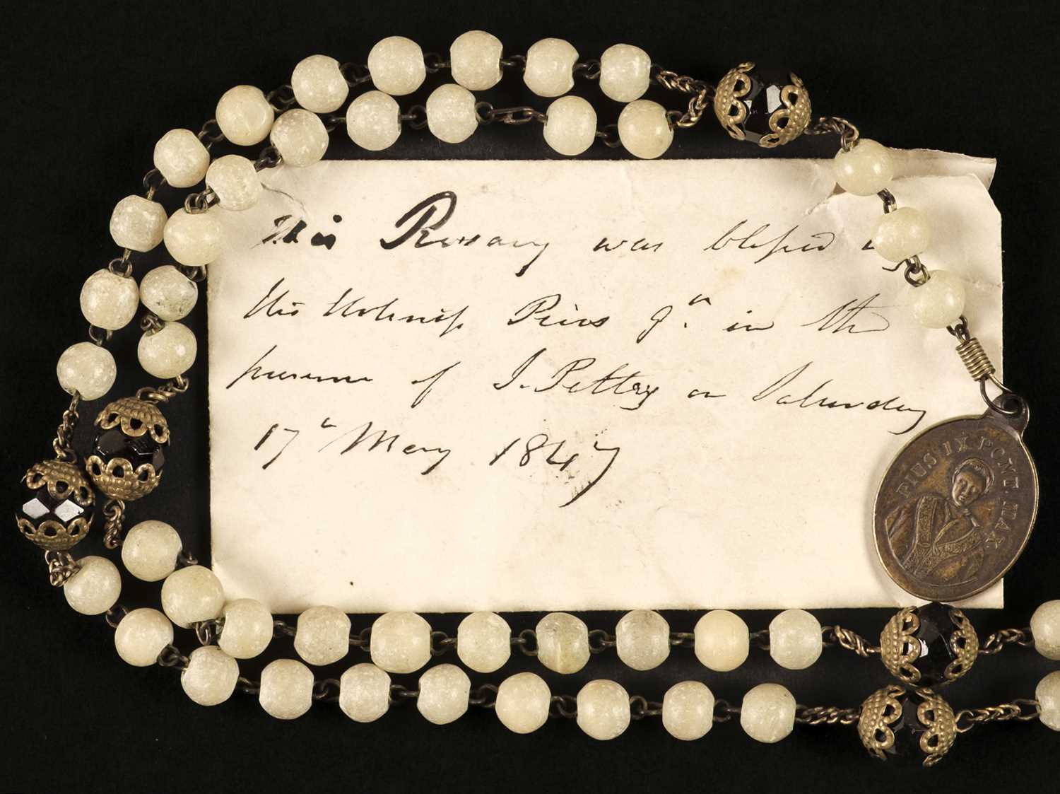 Lot 317 - Pope Pius IX (1792-1878). A white and coloured glass with metal rosary with small medal