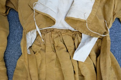 Lot 423 - Clothing. A gold moiré silk maternity gown, circa 1820s