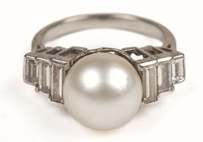 Lot 623 - Pearl ring. A pearl and diamond platinum ring