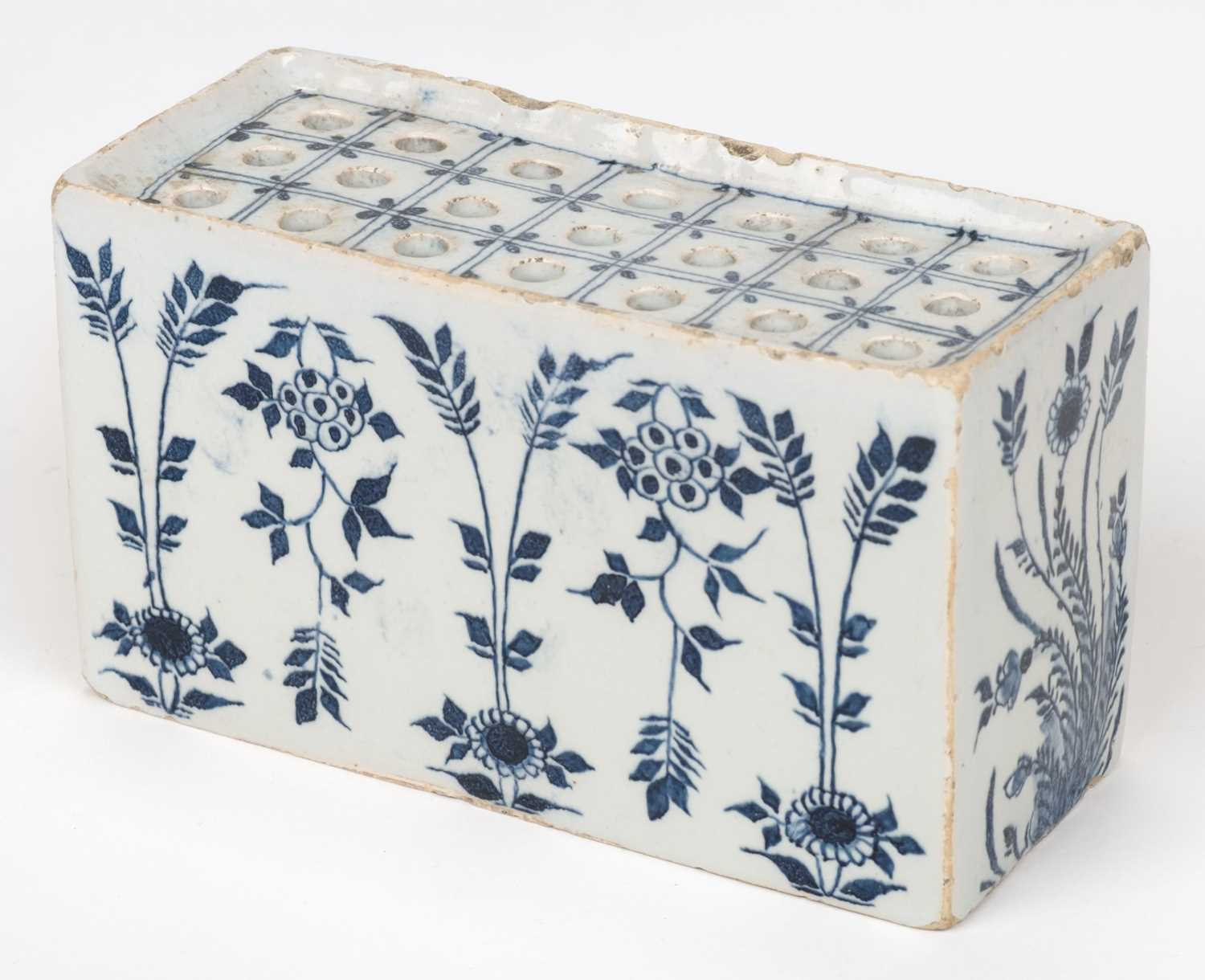 Lot 531 - Delft. An English delft blue and white flower brick, circa 1750