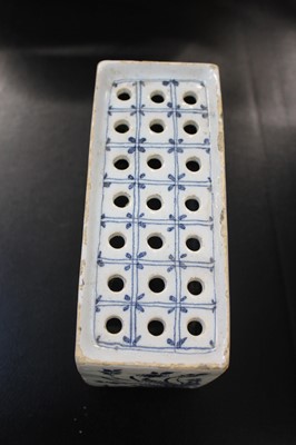 Lot 531 - Delft. An English delft blue and white flower brick, circa 1750