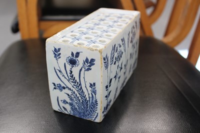 Lot 531 - Delft. An English delft blue and white flower brick, circa 1750