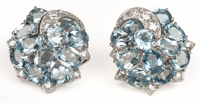 Lot 625 - Earrings. A pair of platinum clip earrings, set with facet-cut aquamarine and diamond stones
