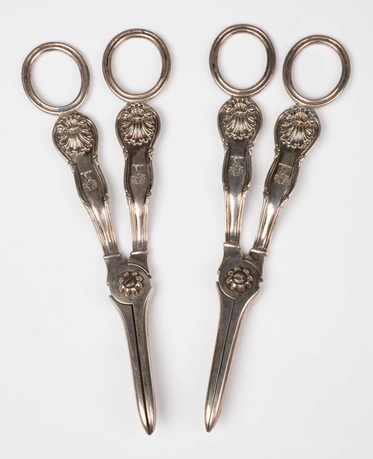 Lot 609 - Silver grape scissors. Two pairs of George IV Silver grape scissors by William Eley II, London, 1826