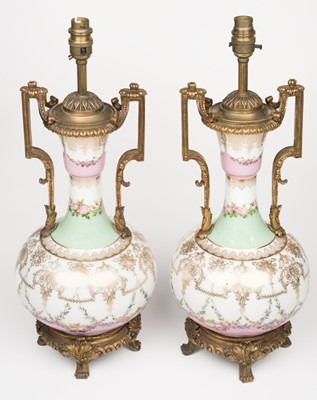 Lot 589 - Table lamps. A pair of continental porcelain and ormolu table lamps, late 19th century