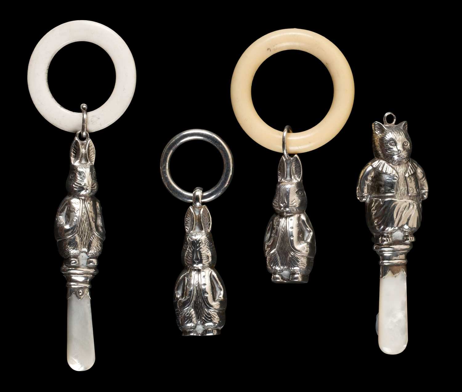 Lot 153 - Potter (Beatrix). A silver Peter Rabbit rattle and teething ring, 1967, & others