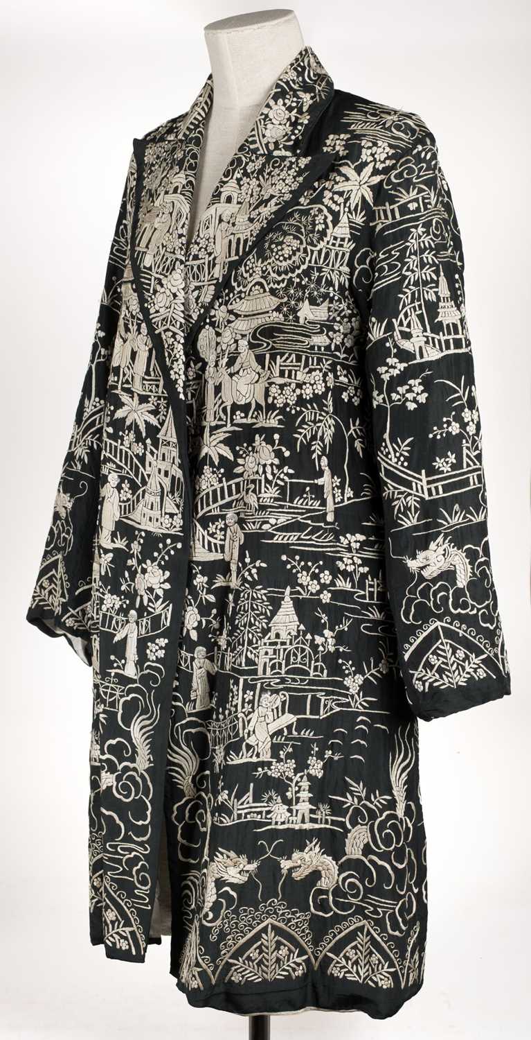 Lot 456 - Chinese. An embroidered coat, early 20th century, & an embroidered jacket and skirt