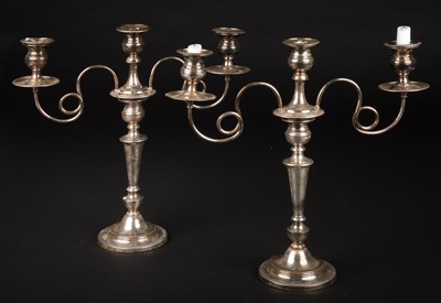Lot 692 - Candelabras. A pair of silver-plated three-light candelabras, circa 1900
