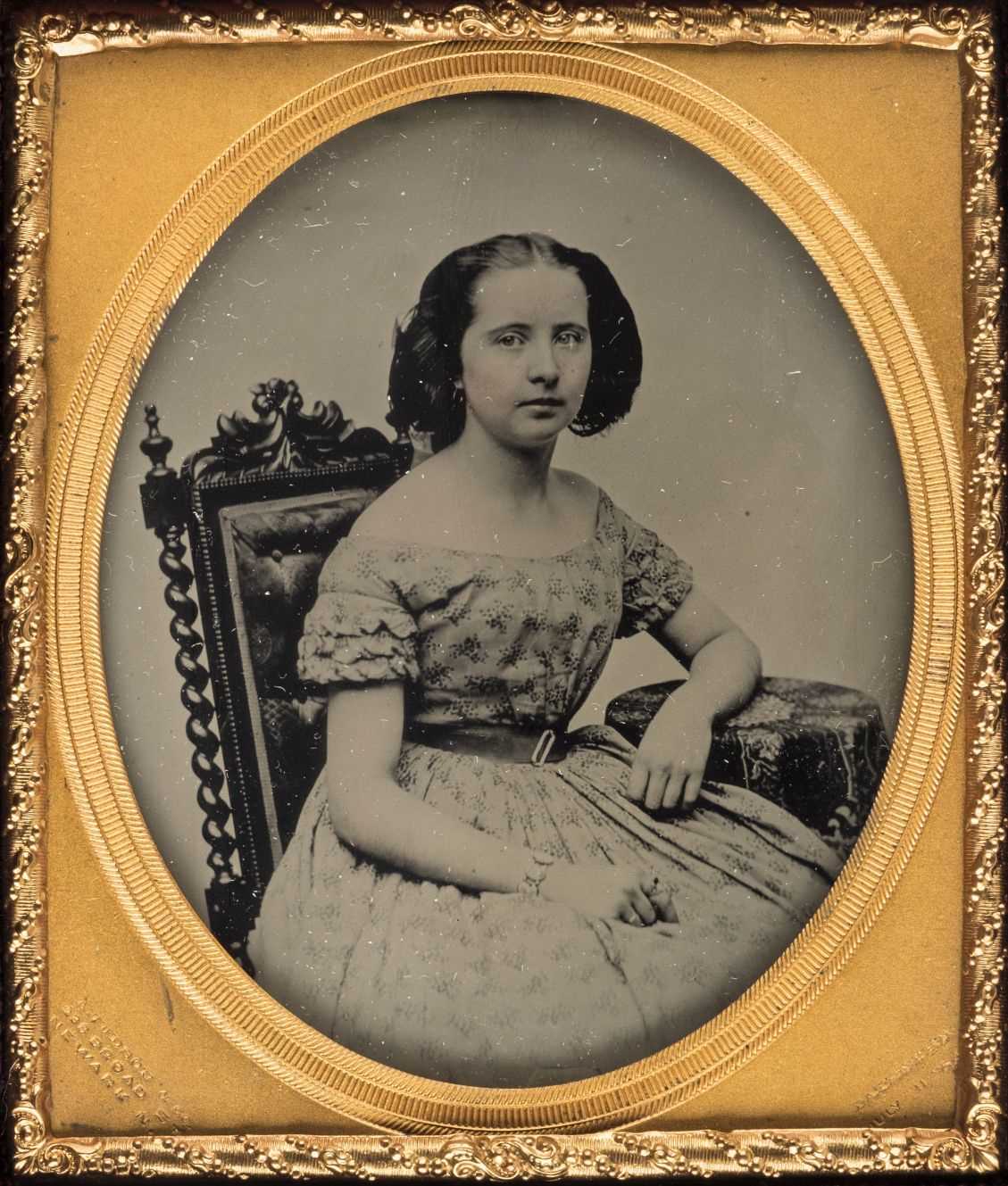 Lot 326 - Sixth-plate ambrotype of a seated girl, by A. Judson & Sons, 238 Broad Street, Newark, NJ